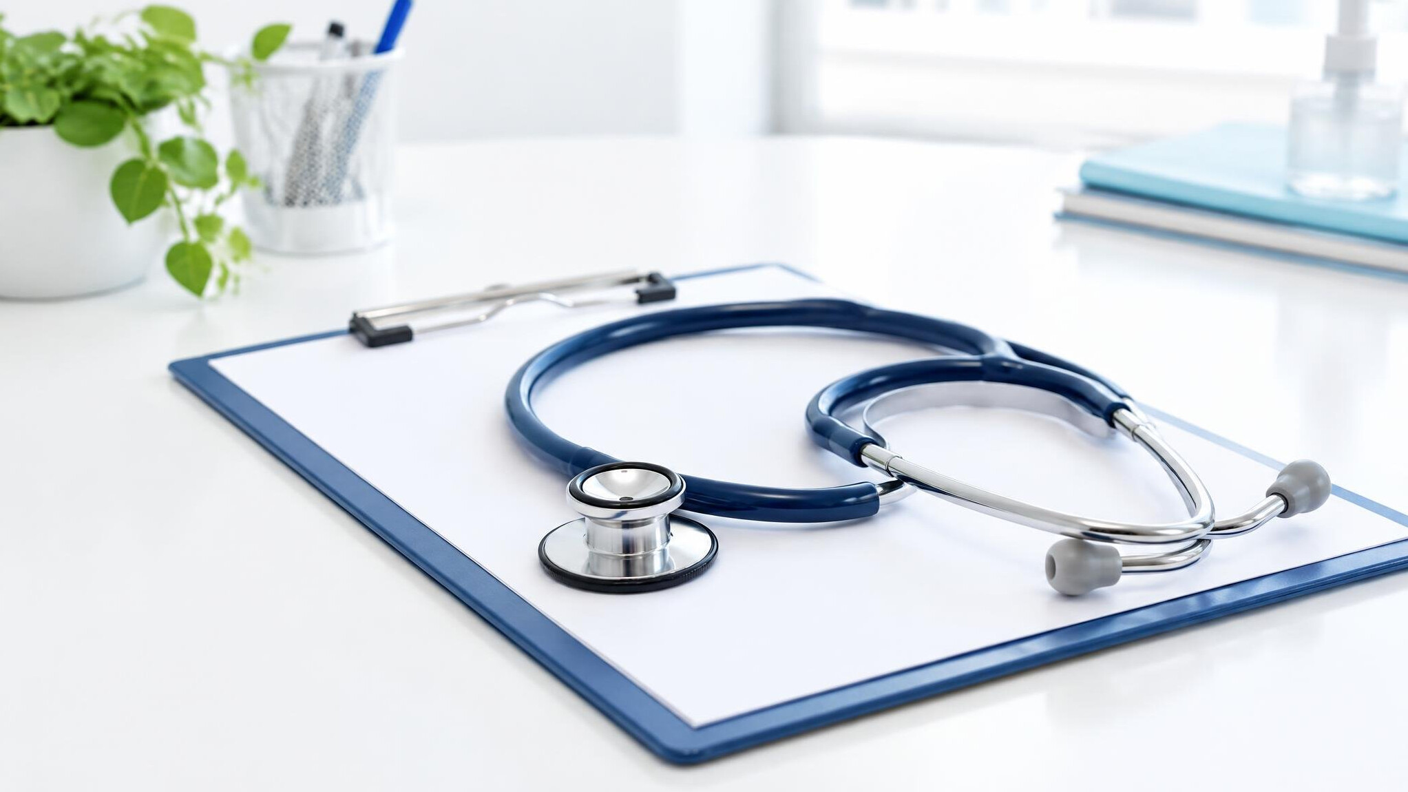 Stethoscope and clipboard on a clean desk